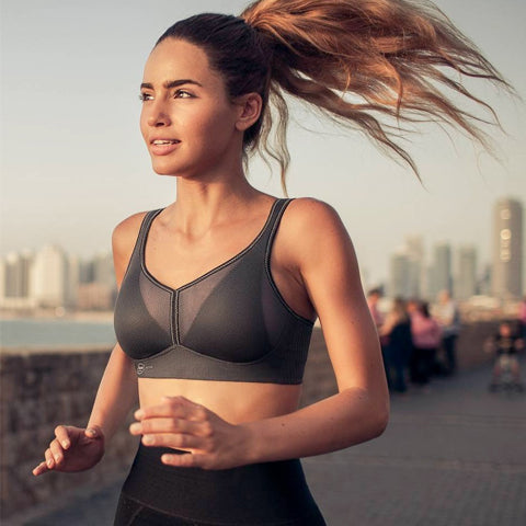Woman running with grey anita sports bra