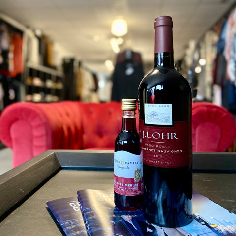 Private Shopping Event J.Lohr Red Wine in front of clothing racks and red couch