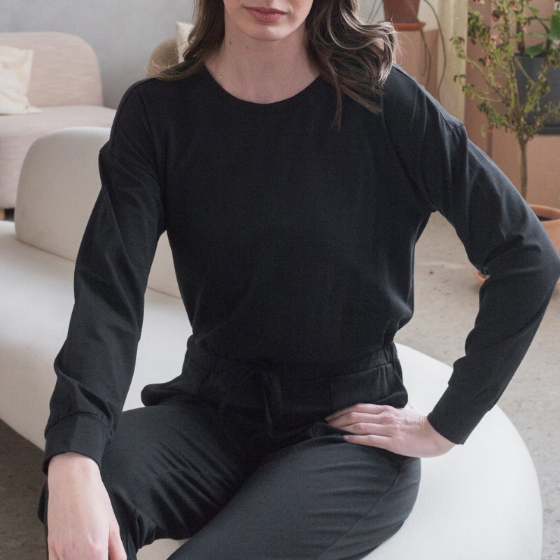 woman in full black romper with drawstring waist