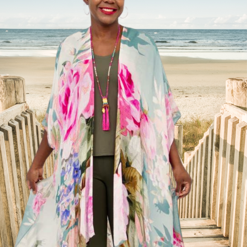Woman on beach with blue sky darcy wrap in blue and pink florals